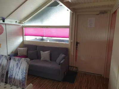 a living room with a couch and a window at Spa Cottage Lavender in Terme Čatež in Čatež ob Savi
