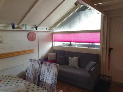 a living room with a couch and a window at Spa Cottage Lavender in Terme Čatež in Čatež ob Savi
