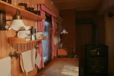 a room with a wood stove in a house at Chalet Kočna - I FEEL ALPS in Stahovica