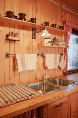 a kitchen with a sink and a counter with towels at Chalet Kočna - I FEEL ALPS in Stahovica