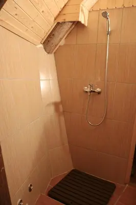 a bathroom with a shower with a bench in it at Chalet Kočna - I FEEL ALPS in Stahovica