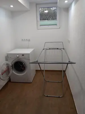 a laundry room with a washing machine and a window at Apartment by Tanja&Nejc in Bled