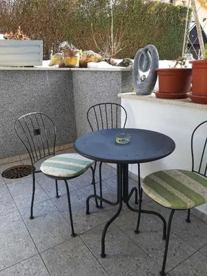 two chairs and a table and two tables and chairs at Apartment by Tanja&Nejc in Bled