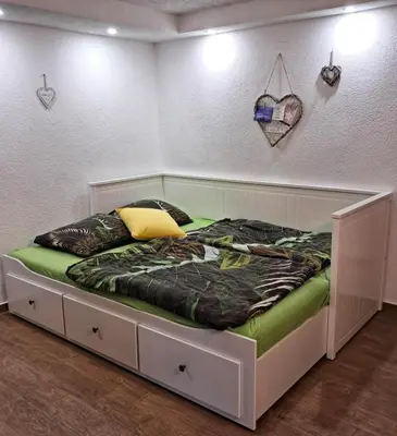 a bed in the corner of a room at Apartment by Tanja&Nejc in Bled