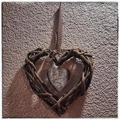 a heart made out of rope on a wall at Apartment by Tanja&Nejc in Bled