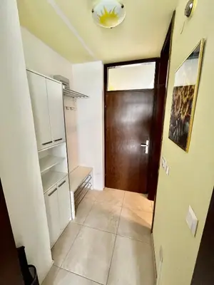 a hallway with a door and a tiled floor at Apartment TiSa, Bovec in Bovec