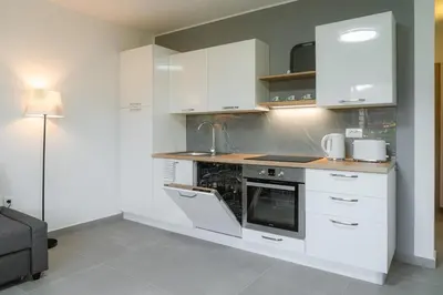 a kitchen with white cabinets and a stove at Apartma BoLeRo in Tolmin
