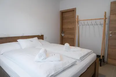 a bedroom with two beds with white towels on them at Apartma BoLeRo in Tolmin
