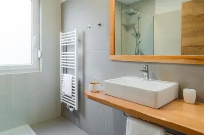 a bathroom with a white sink and a mirror at Apartma BoLeRo in Tolmin