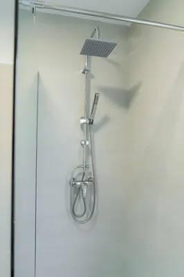 a shower with a light on the wall at Apartma BoLeRo in Tolmin