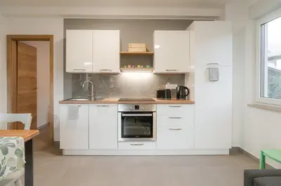 a kitchen with white cabinets and an oven at Apartma BoLeRo in Tolmin