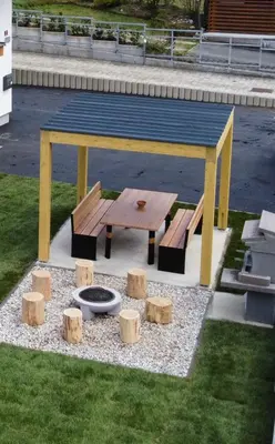 a picnic table and benches in a park at Apartmaji ENIA Rateče-Planica, Kranjska Gora in Kranjska Gora