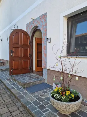 a building with a door and a flower pot in front of it at Krka River Lodge in Krka