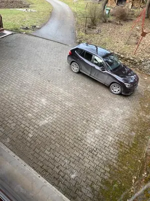 a car is parked on a driveway at Apartma Regina in Slovenj Gradec