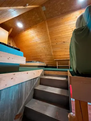 an empty sauna with wooden walls and wooden stairs at Koča Janka in Metke in Velika Loka