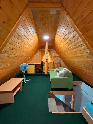 a room with a bed and a desk in a cabin at Koča Janka in Metke in Velika Loka