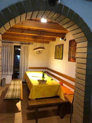 a room with a table with a yellow table cloth at Adorable guesthouse in the middle of vineyards in Ptujska Gora
