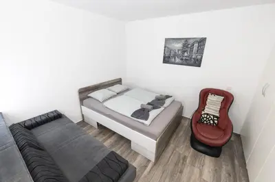a small bedroom with a bed and a couch at Rakita Premium Family Suite in Moravske Toplice