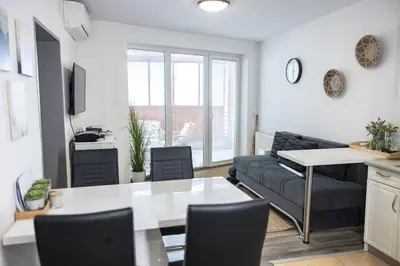 a living room with a table and a couch at Rakita Premium Family Suite in Moravske Toplice