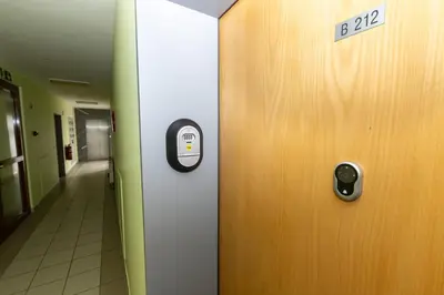a door in a hallway with a sign on it at Rakita Premium Family Suite in Moravske Toplice