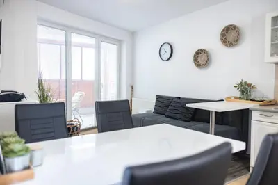 a living room with a couch and a table at Rakita Premium Family Suite in Moravske Toplice