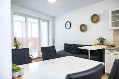 a living room with a couch and a table at Rakita Premium Family Suite in Moravske Toplice