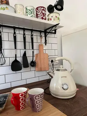 a kitchen counter with a tea kettle and cups at Hisa STERNA - WELL HOUSE in Zgornje Škofije