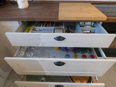 a drawer in a desk with many different items at Hisa STERNA - WELL HOUSE in Zgornje Škofije