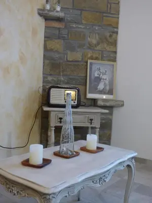a room with a table with two candles and a tv at Hisa STERNA - WELL HOUSE in Zgornje Škofije