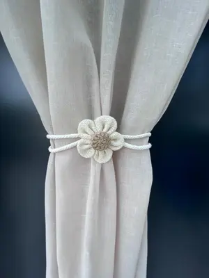a close up of a white curtain with a flower on it at Hisa STERNA - WELL HOUSE in Zgornje Škofije