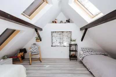a attic bedroom with a bed and skylights at Serenity in Dramlje