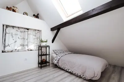 a bedroom with a bed and a window at Serenity in Dramlje
