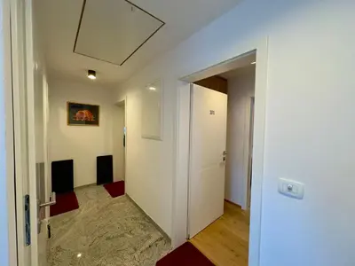 a hallway with a white door and a room at Apartmaji Kotnik in Kranjska Gora