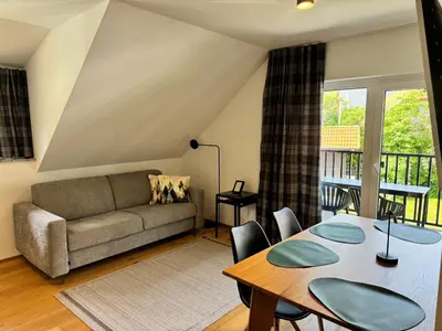 a living room with a table and a couch at Apartmaji Kotnik in Kranjska Gora