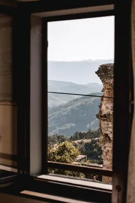 a window in a building looking out at a view at Vila Ana in Štanjel