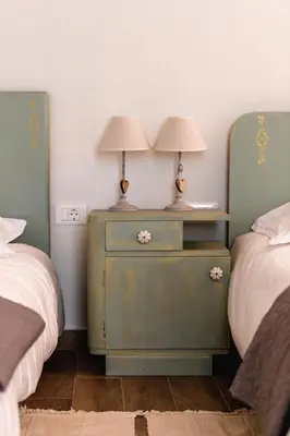 two lamps on a night stand next to two beds at Vila Ana in Štanjel