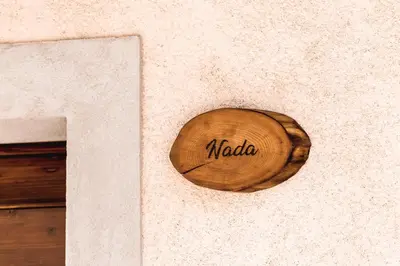 a wooden sign on the side of a wall at Vila Ana in Štanjel
