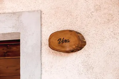 a wooden sign on the side of a building at Vila Ana in Štanjel