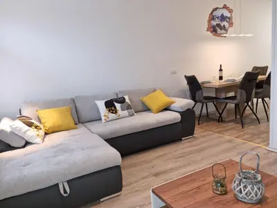 a living room with a couch and a table at APARTMA KAAN in Žaga