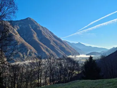 a view of a mountain with a plane flying over it at APARTMA KAAN in Žaga