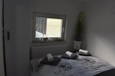 a bedroom with a bed with towels and a window at Apartma VRBA Dobrna in Dobrna