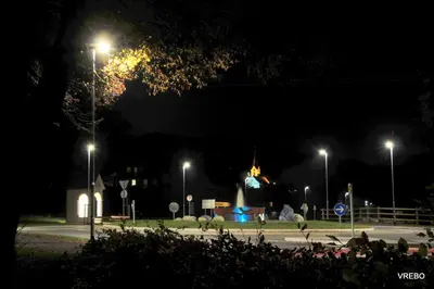 a parking lot with street lights at night at Apartma VRBA Dobrna in Dobrna