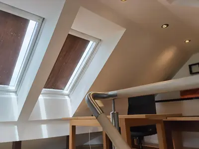 a staircase with two windows in a house at BALCON Apartments in Bled