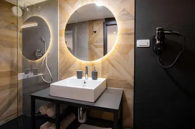 a bathroom with a white sink and a mirror at Rooms Bolero Naklo in Naklo