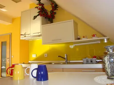 a kitchen with yellow walls and a sink at Oriana Studios in Bled