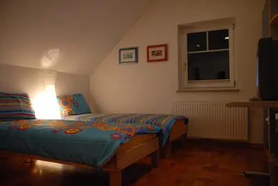 a bedroom with two twin beds and a window at Oriana Studios in Bled