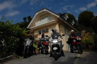 a group of motorcycles parked in front of a house at Oriana Studios in Bled