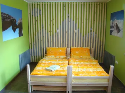 a bed in a room with green walls at Oriana Studios in Bled