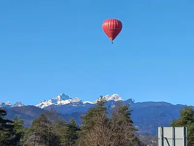 a hot air balloon in the sky with mountains at Oriana Studios in Bled