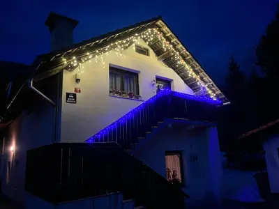 a house with blue lights on the stairs at Apartma Anastasija in Kranjska Gora